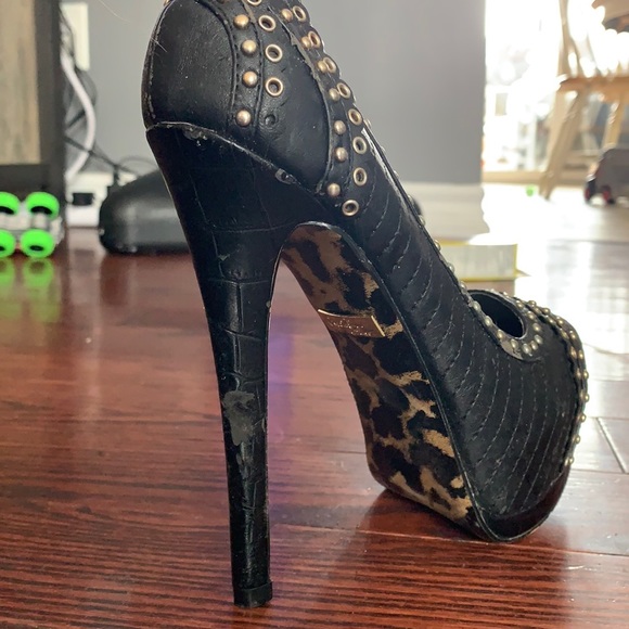 Very high black heels with gold detail. - Picture 2 of 4